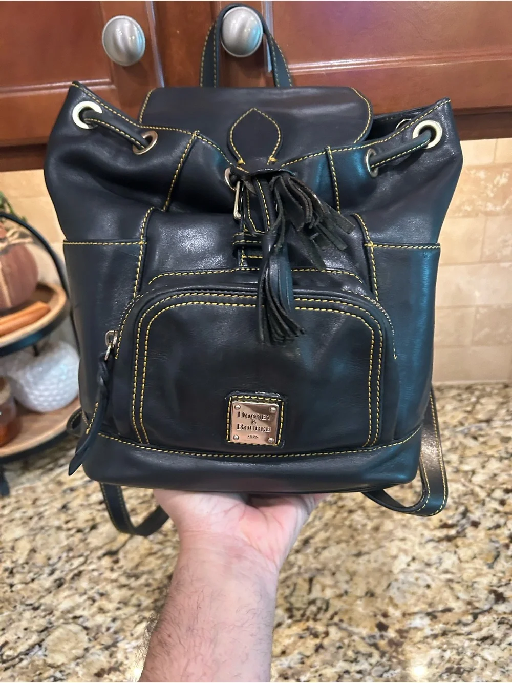 Dooney & Bourke Black Leather Drawstring Backpack with Yellow Stitching
